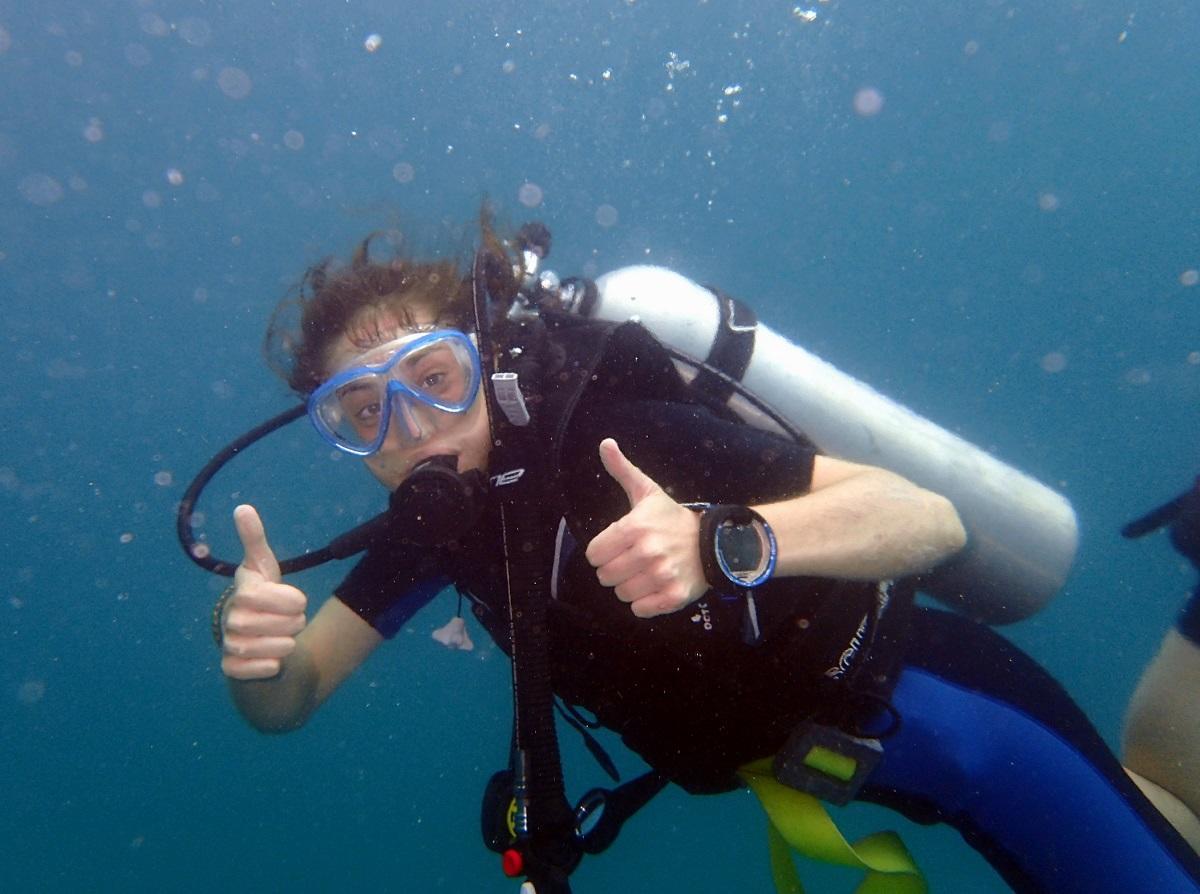 Conservation volunteer gives a thumbs up while completing a survey dive Volunteer gives a thumbs up during her Conservation Project abroad