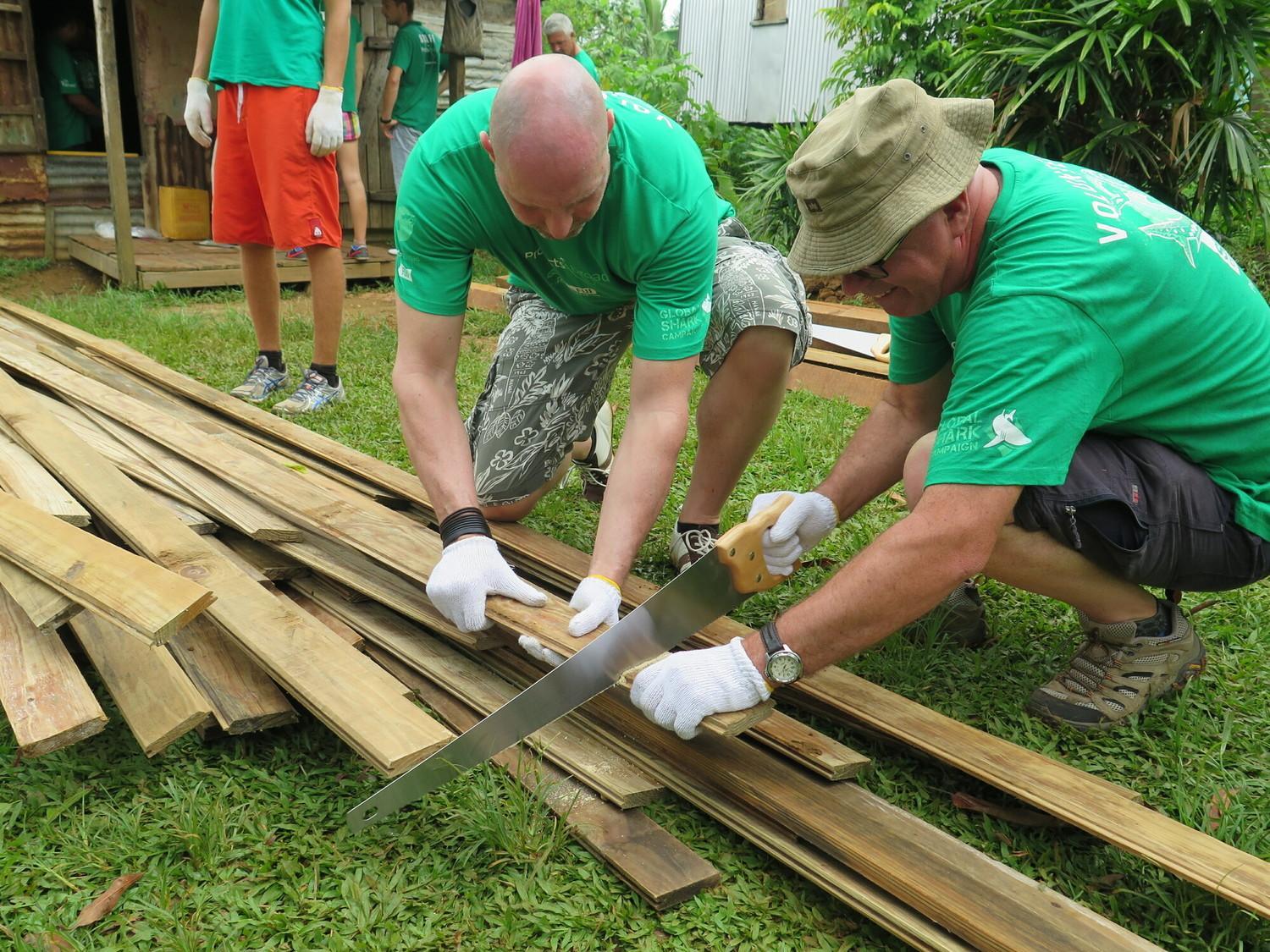 Projects Abroad volunteers work together as part of their voluntary work for retirees Retired professionals volunteer on a building project in Fiji