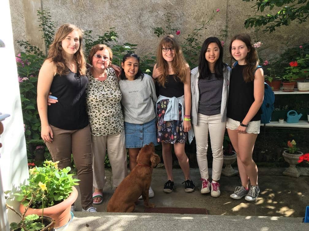 Host mother takes care of the volunteers that stay with her during their trip in Romania. Projects Abroad volunteers take a group photo with their host mother in Romania.