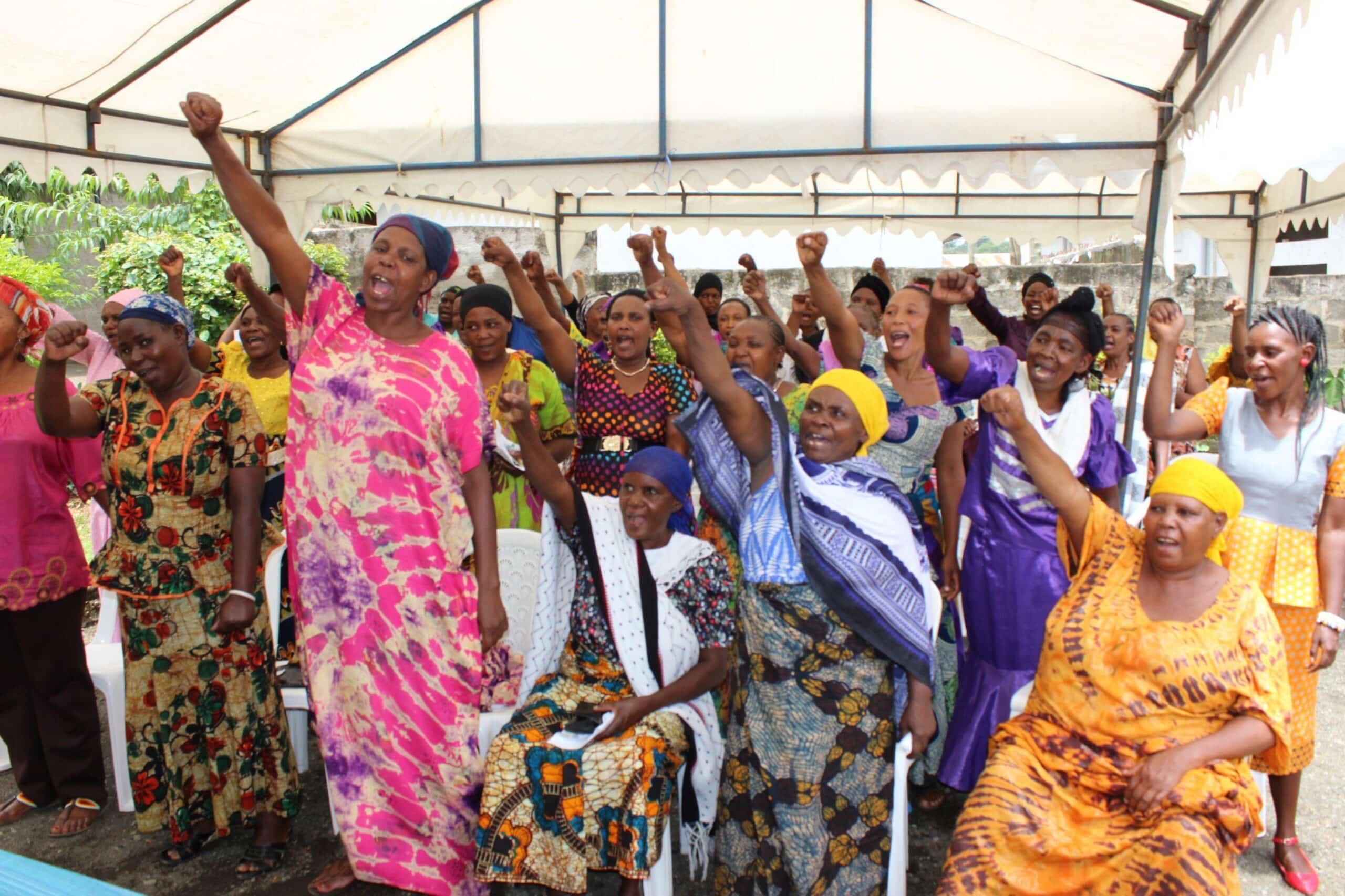 Tanzanian women listen to a human rights talk given by interns on a gap year law internship.