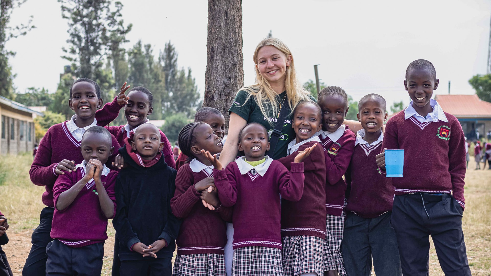 Girl standing with children in Kenya