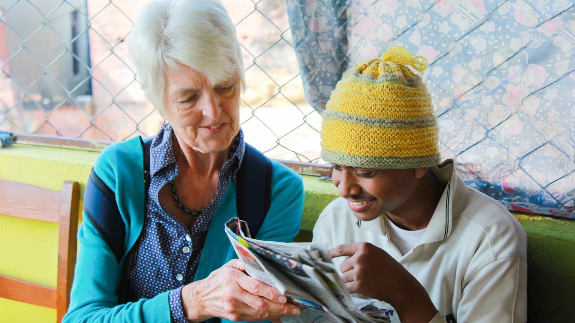 Nepal Older Volunteer Reading With Child