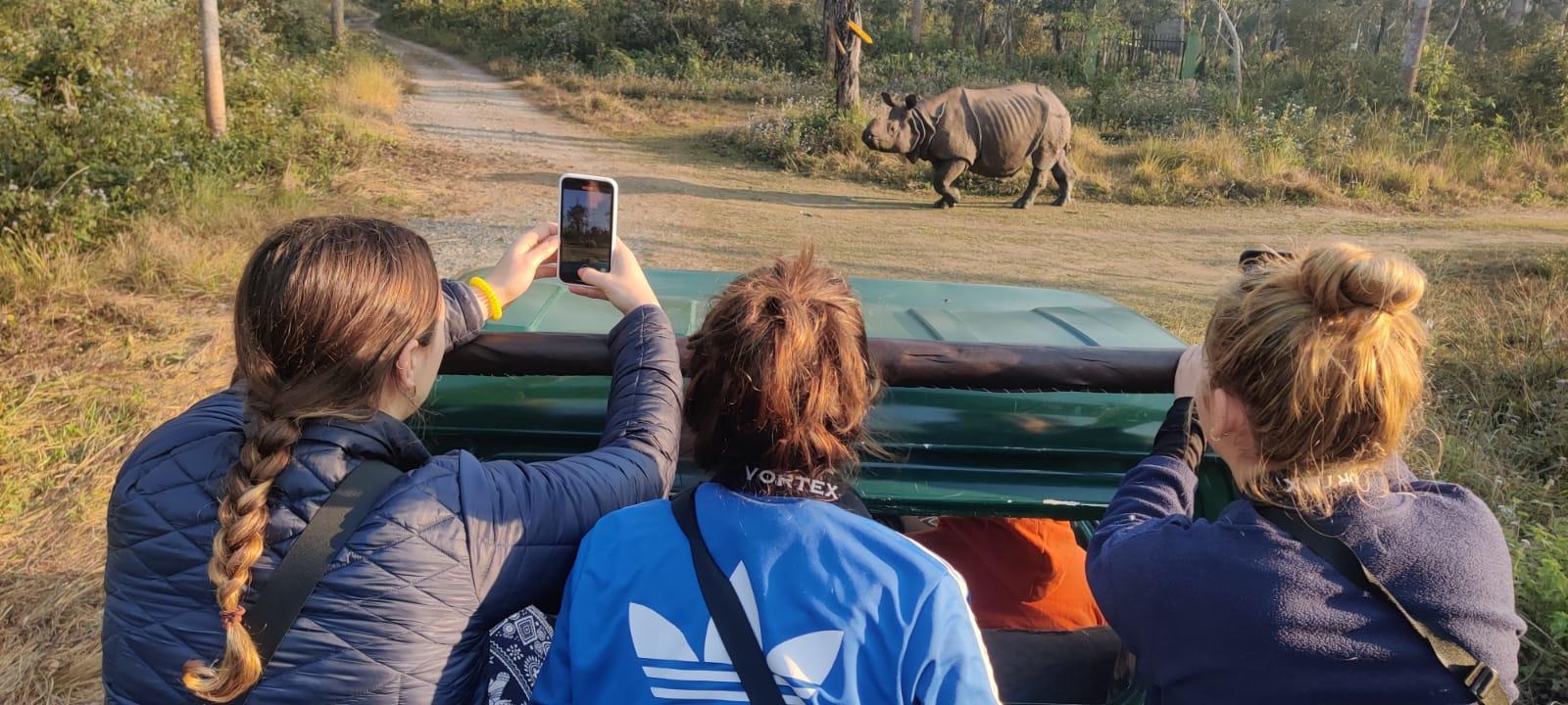 A group of Conservation volunteers spot a rhino in Chitwan, Nepal