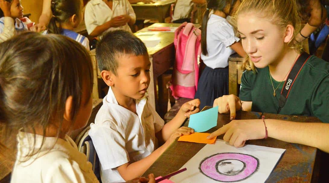 Volunteer helping to teach children in Cambodia