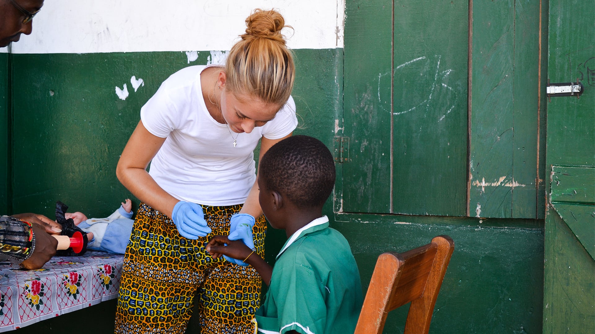 medical intern assisting health screening in Ghana