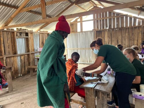 A nutrition intern in Kenya checking blood pressure
