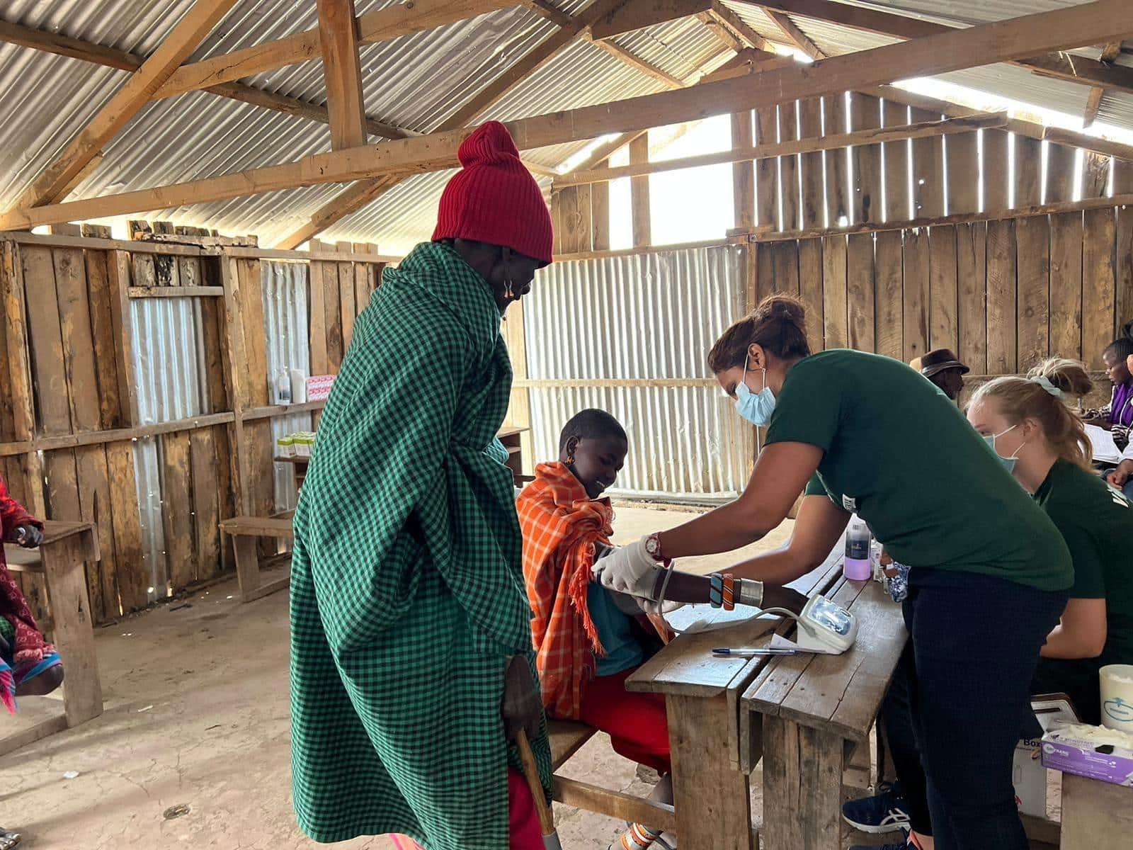 A nutrition intern in Kenya checking blood pressure