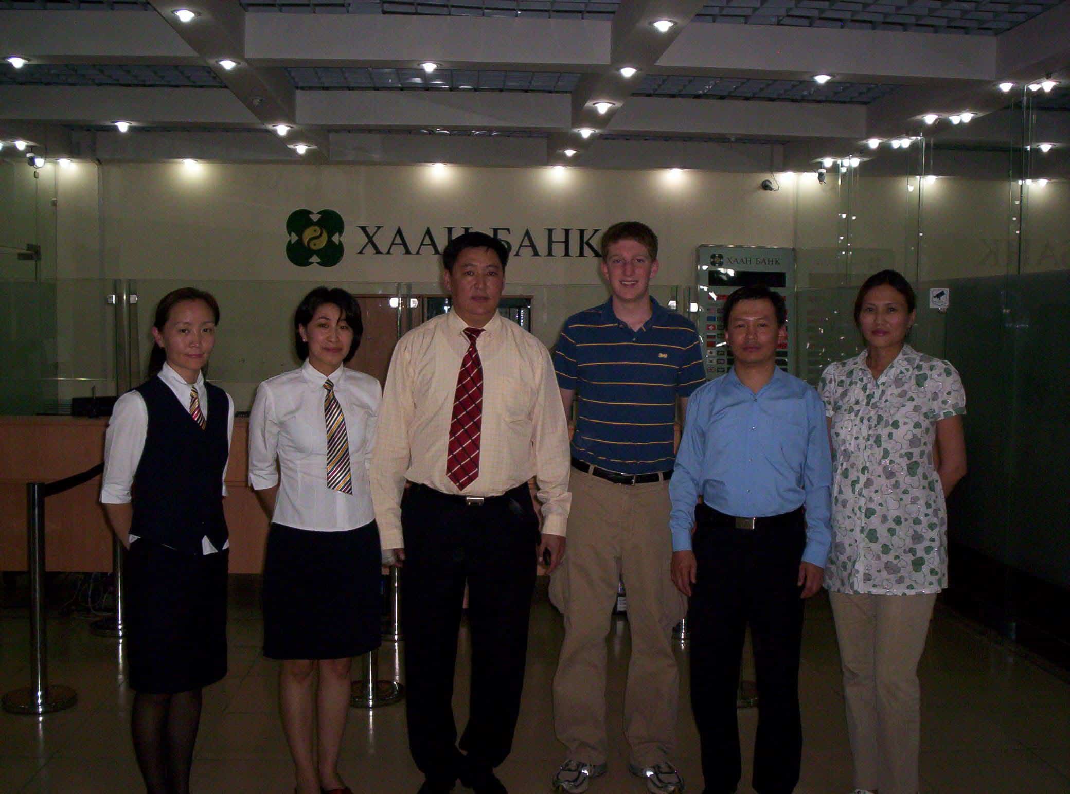 Business Interns pose for a photo with staff at a local bank in Mongolia.