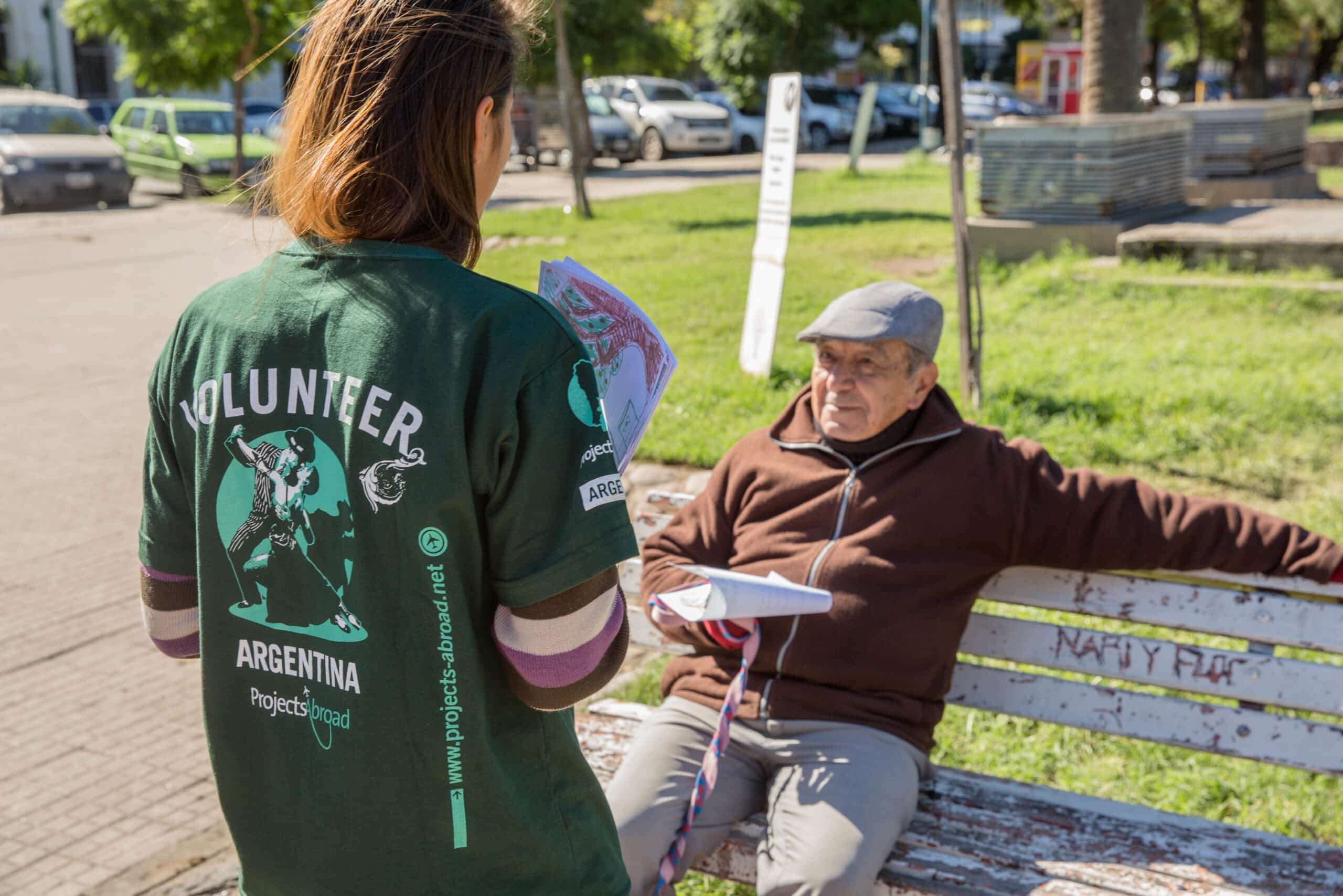 A student speaks to a local man during a campaign on her Human Rights internship in Argentina.