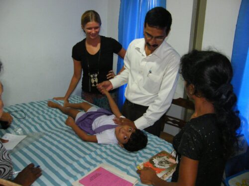 A Projects Abroad intern is pictured watching over a doctor as part of their physiotherapy internship in Sri Lanka.