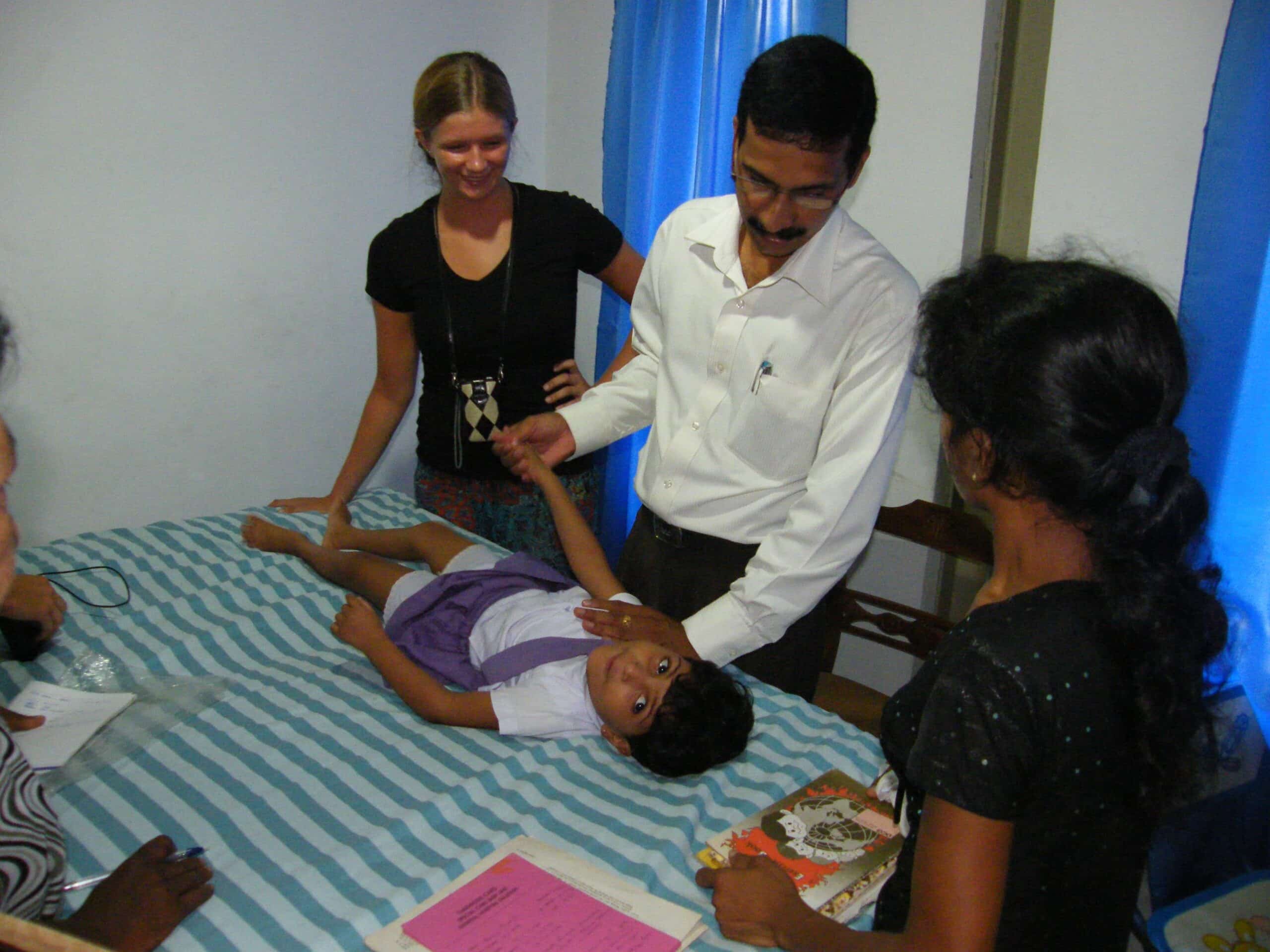 A Projects Abroad intern is pictured watching over a doctor as part of their physiotherapy internship in Sri Lanka.