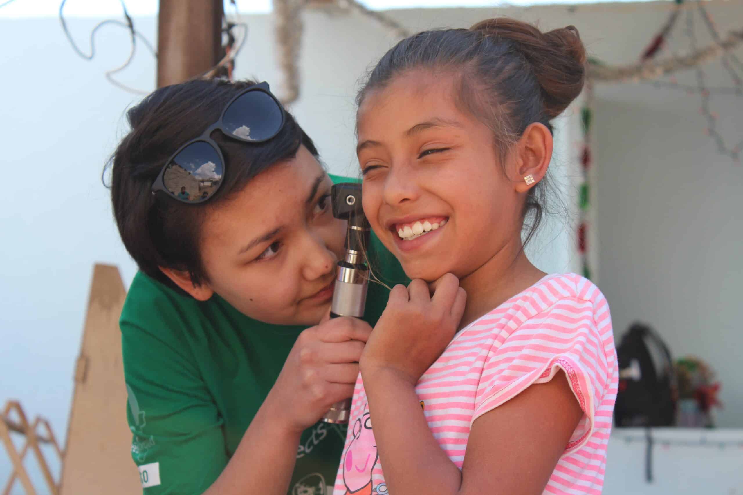 A Projects Abroad work experience intern in Mexico is seen examining a child at local doctors.