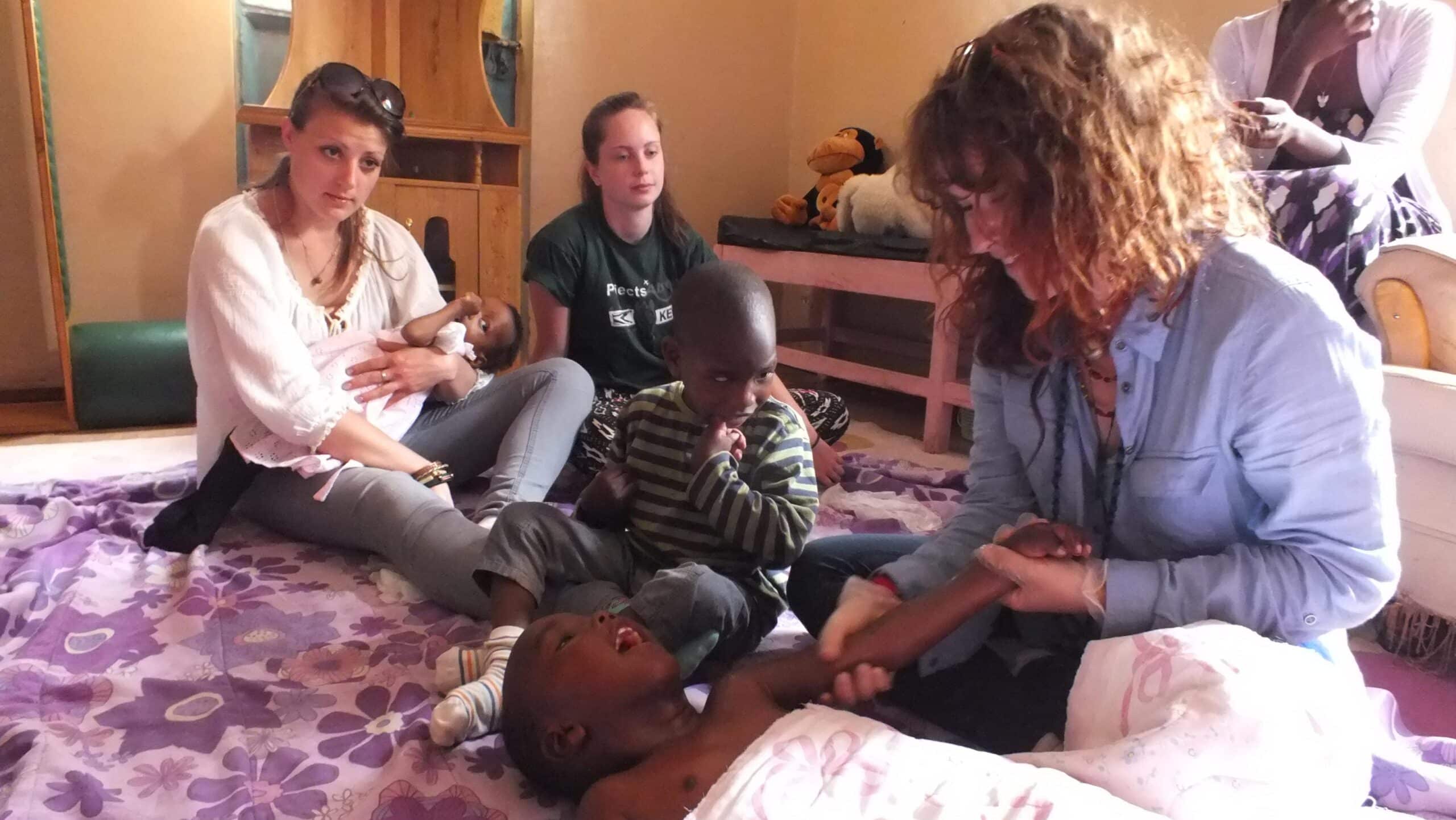 Projects Abroad Intern taking part in a busy physiotherapy session whilst on her occupational therapy internship in Kenya.