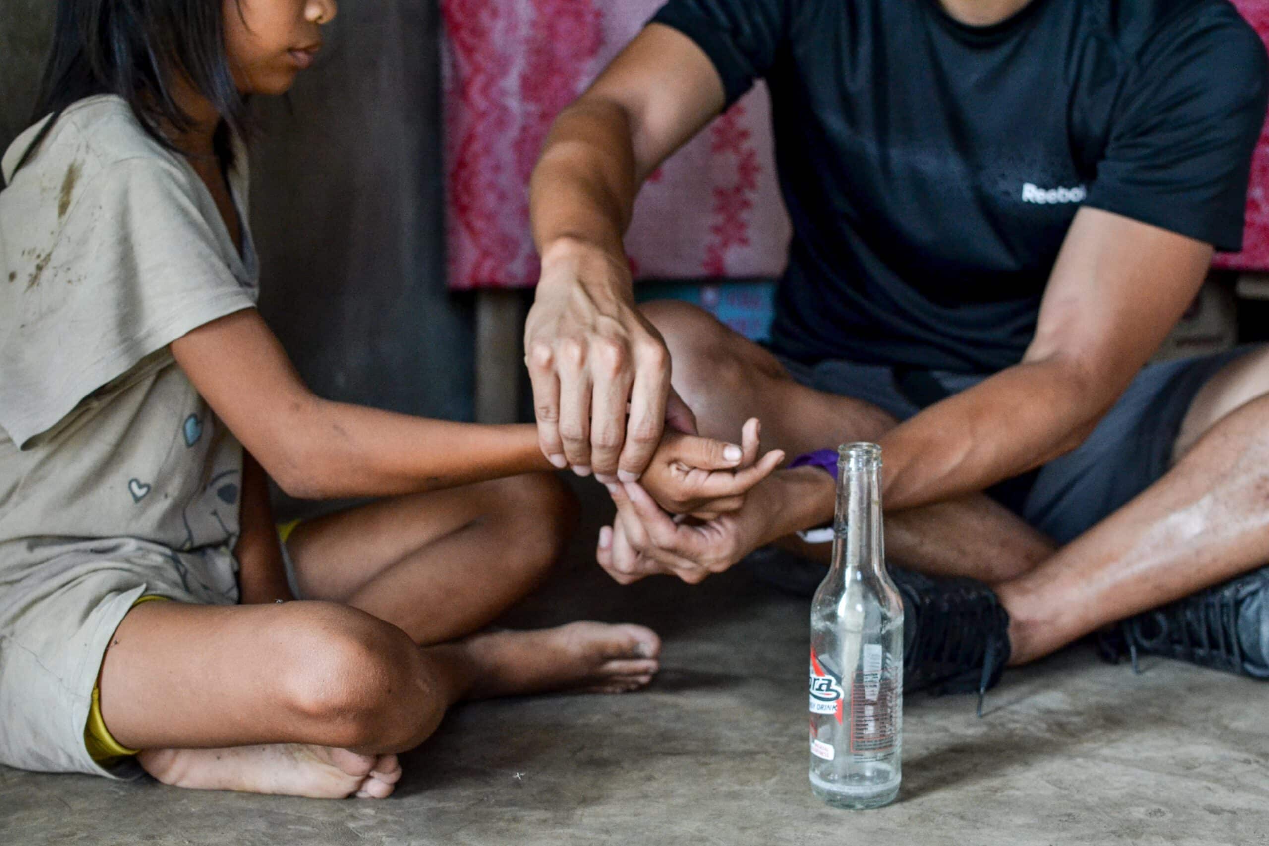 Projects Abroad intern is seen gaining valuable work experience whilst giving physiotherapy to a local child during his physiotherapy internship in the Phillippines.