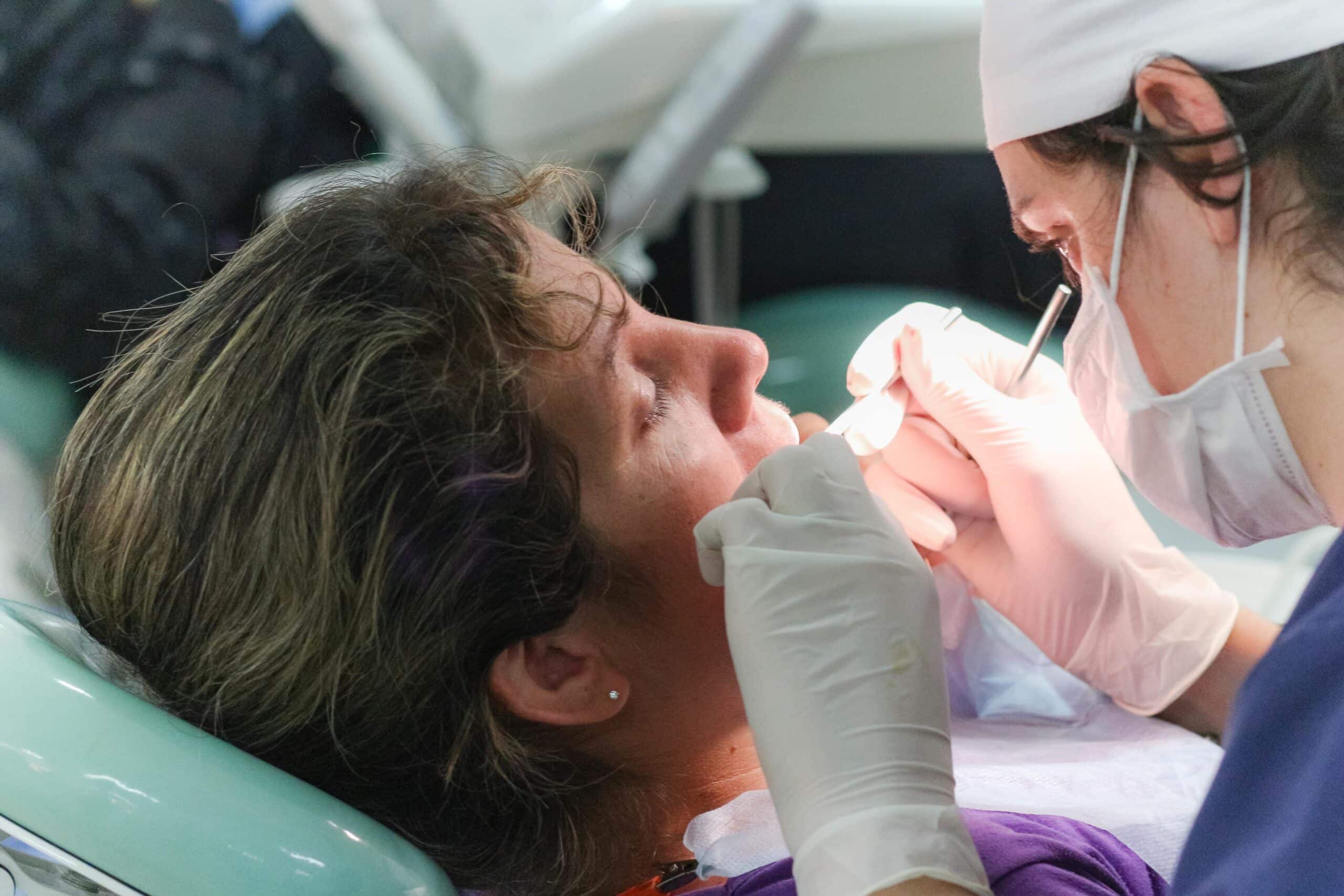 A local dentist treats a patient in Argentina as Projects Abroad dental interns observe for their Dentistry internship