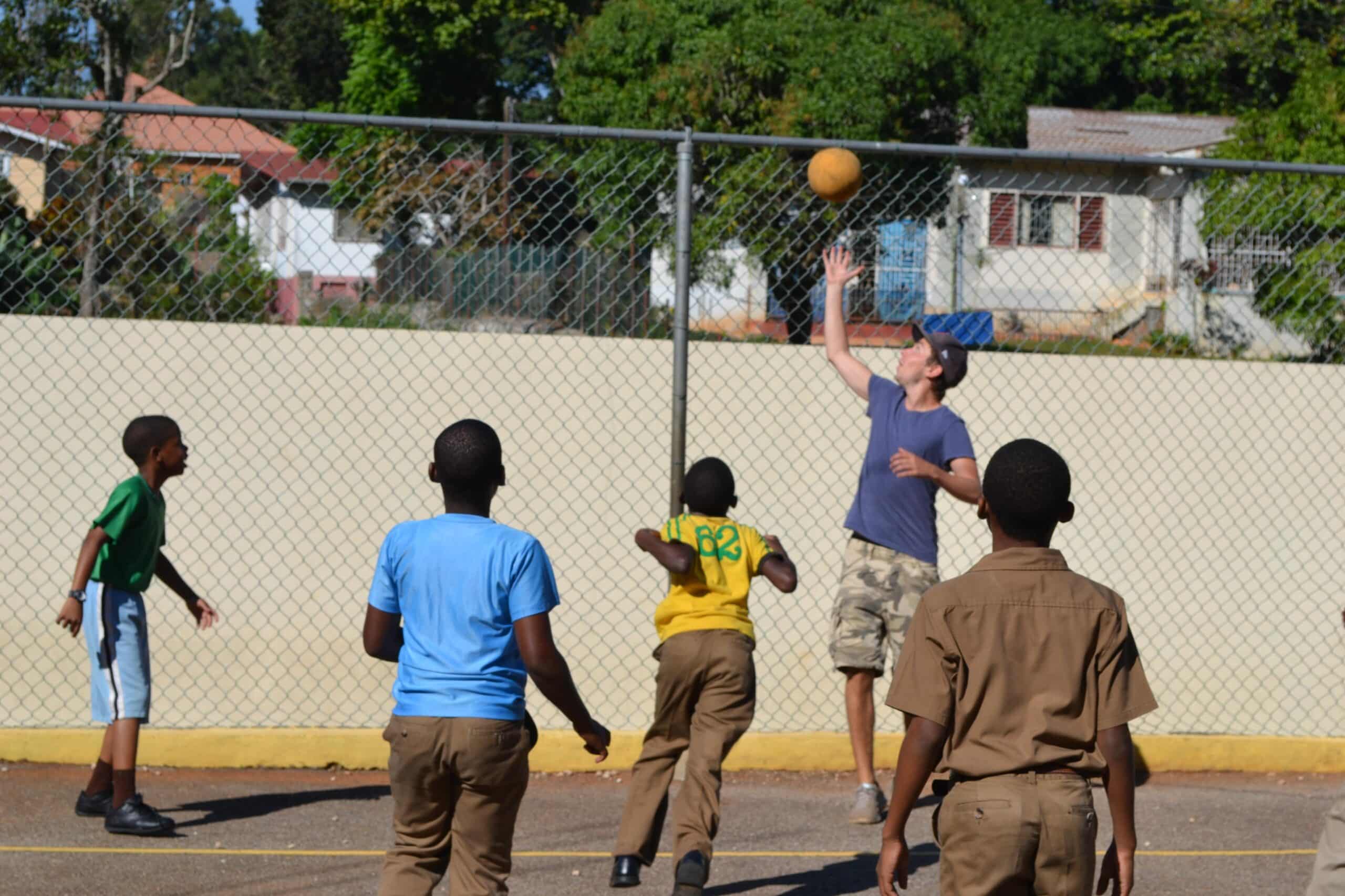 Students learn the basics of basketball during volunteer sports coaching in schools in Jamaica
