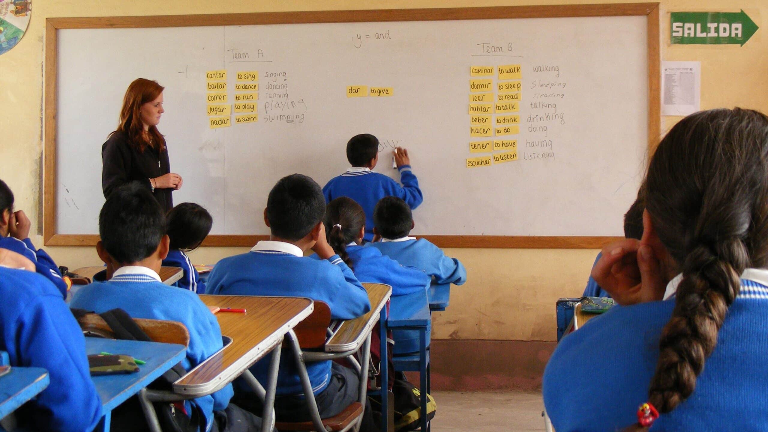 A student finishes an English exercise on the white board at a volunteer teaching placement in Peru.