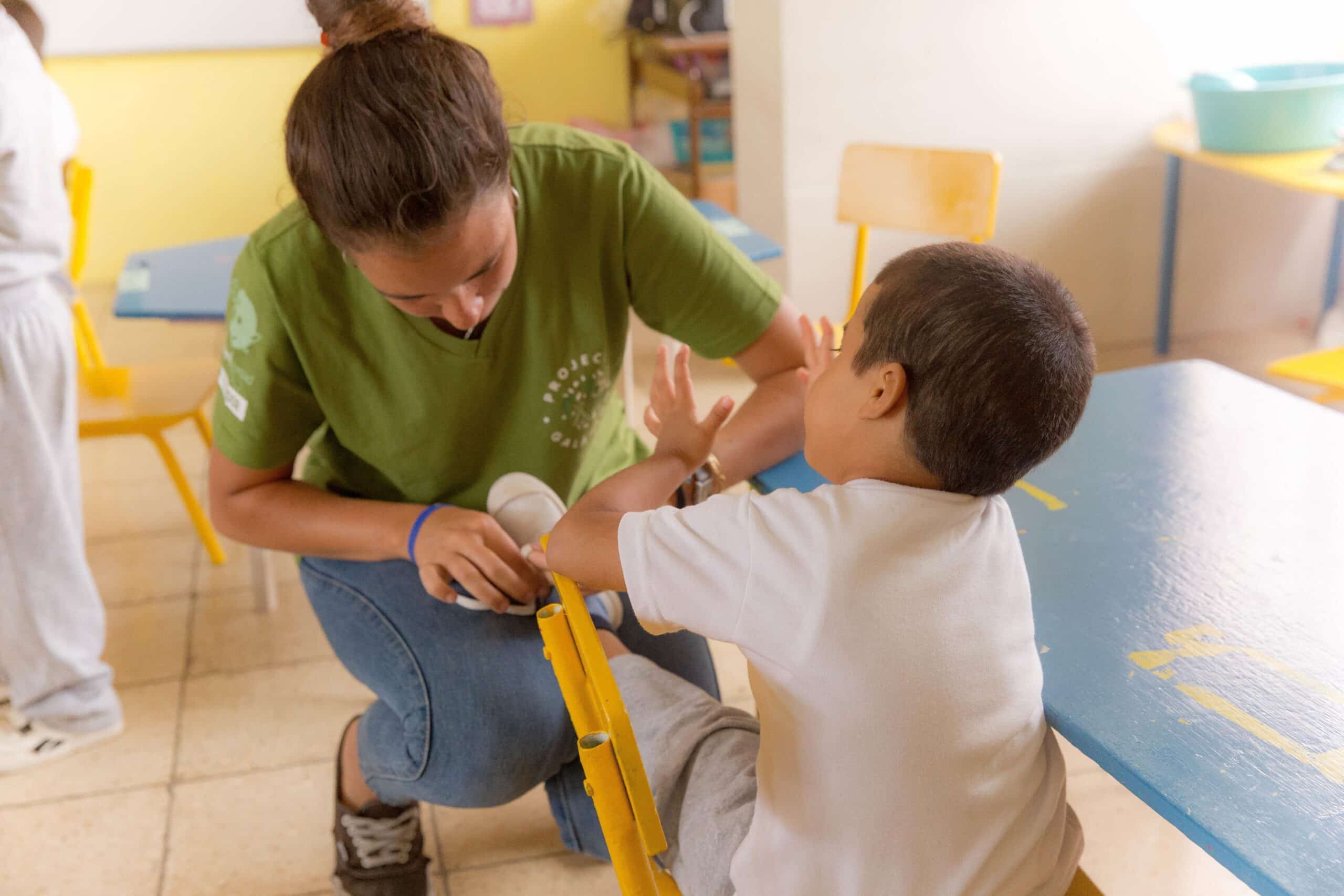 A Projects Abroad intern works with a young boy during her Social Work internship in Ecuador.