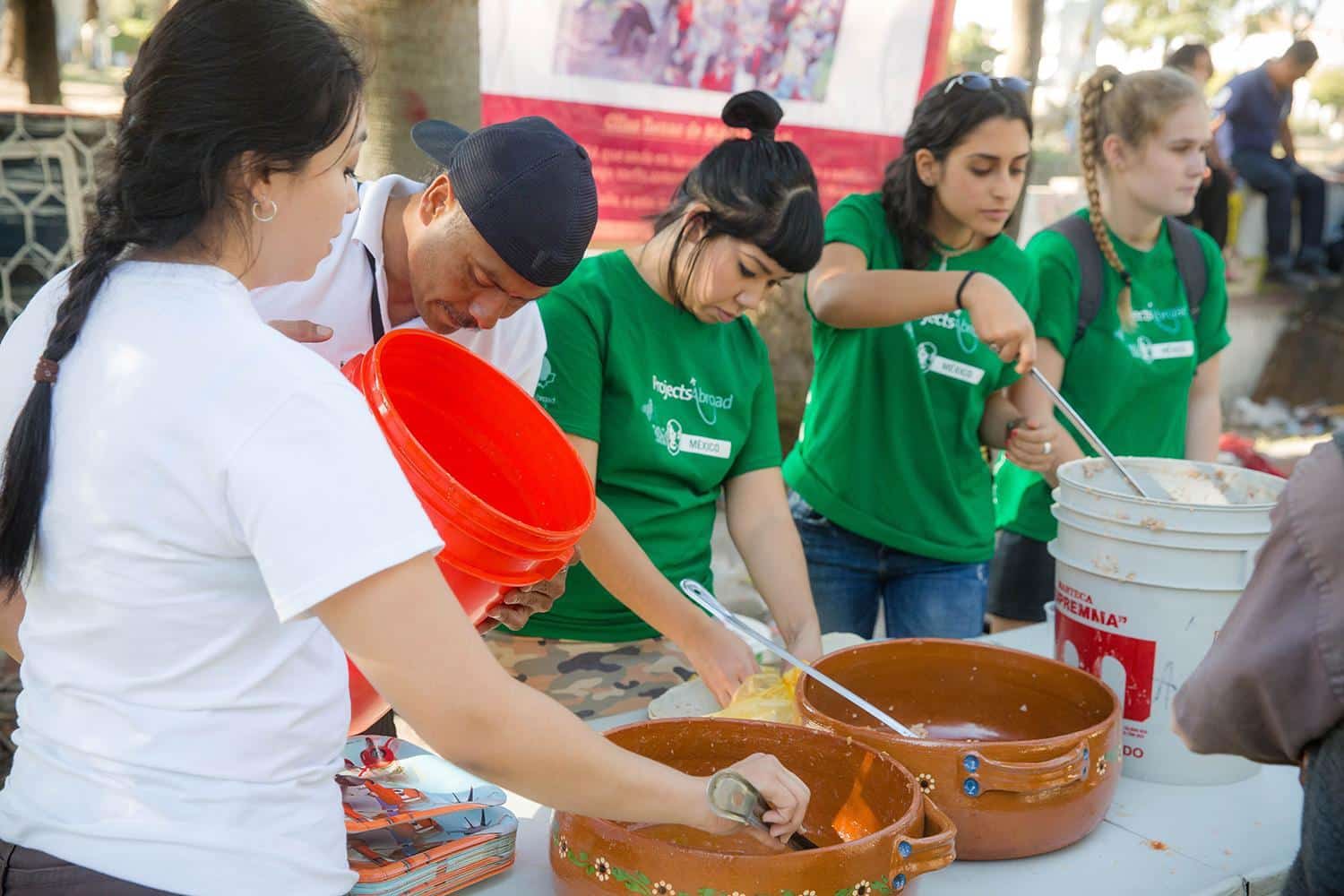 Refugee support volunteers serving food during meal time in Mexico.