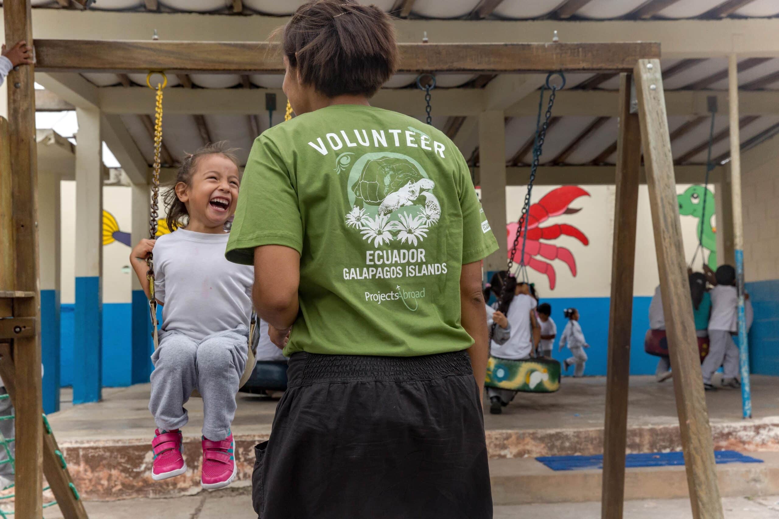 A childcare volunteer in Ecuador supervises children during playtime