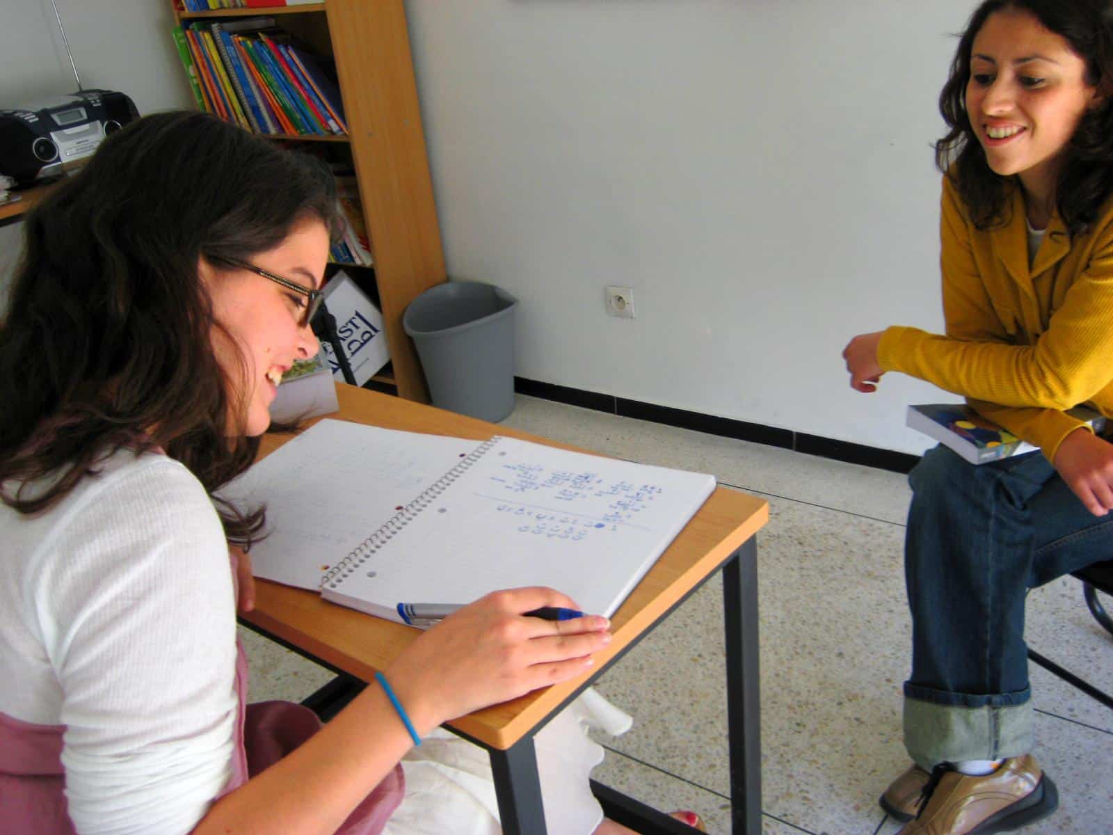 A volunteer takes language courses while volunteering abroad. As part of her cultural exchange program abroad, a volunteer learns a new language.