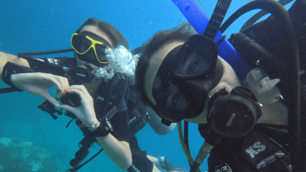 Projects Abroad volunteer receives a monk's blessing in Cambodia Volunteers posing underwater in Thailand