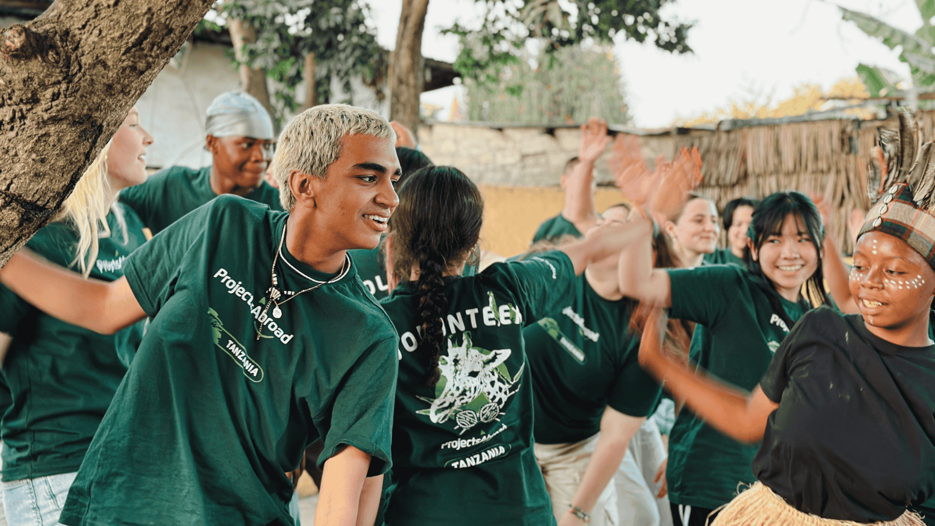 Tanzania important information header image - participants take part in traditional dance